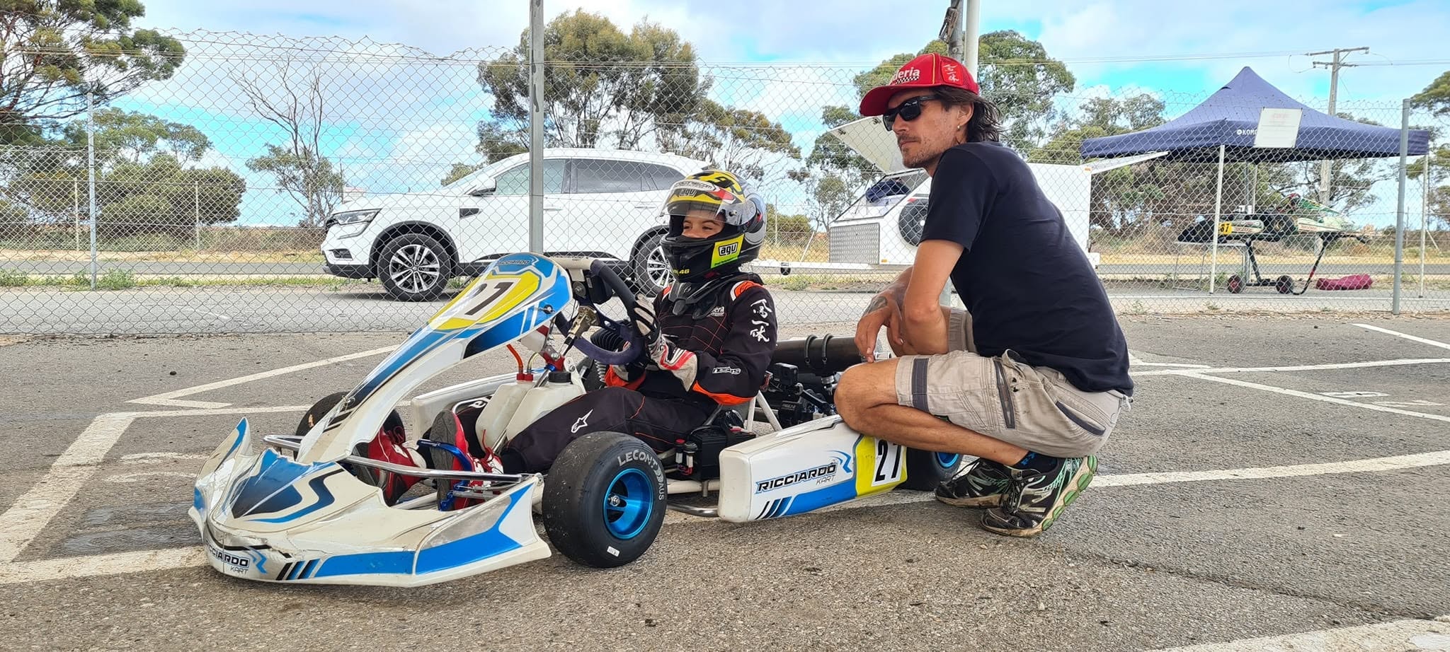 Oceane Colangelo in her go-kart with her coach at a racing facility